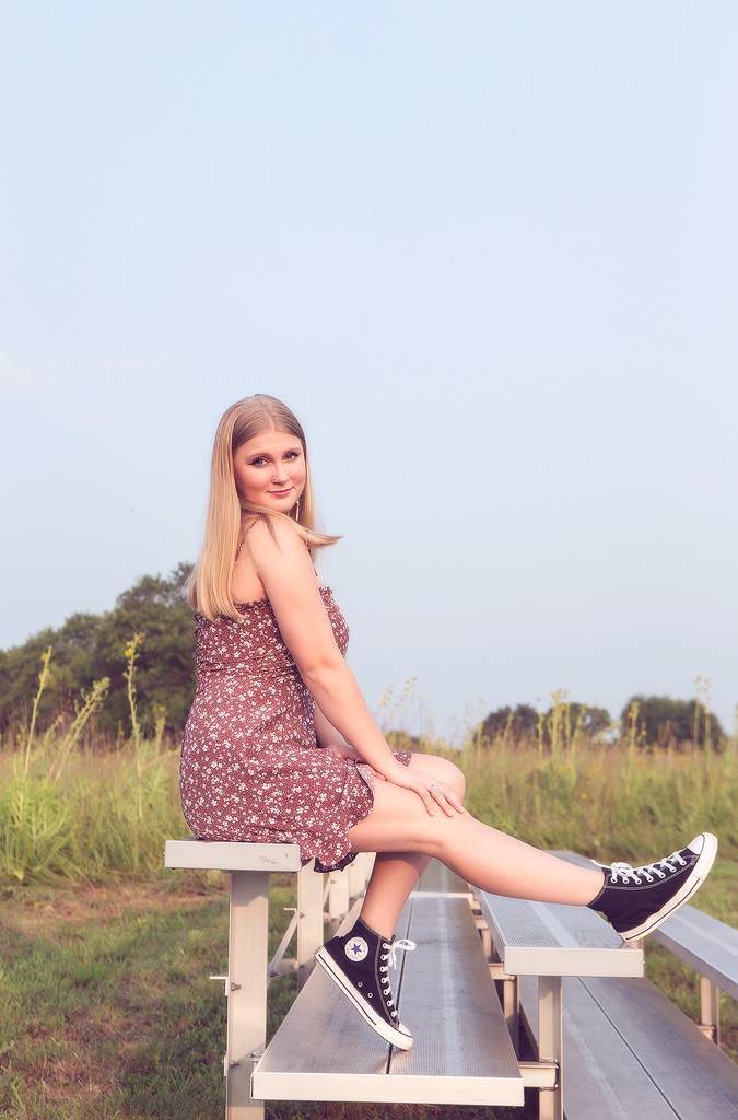 Chicago Senior Photographer 7 Senior photos in the Chicago Suburbs with Marmalade Photography - this senior girl is captured on the bleachers in a beautiful natural prairie setting