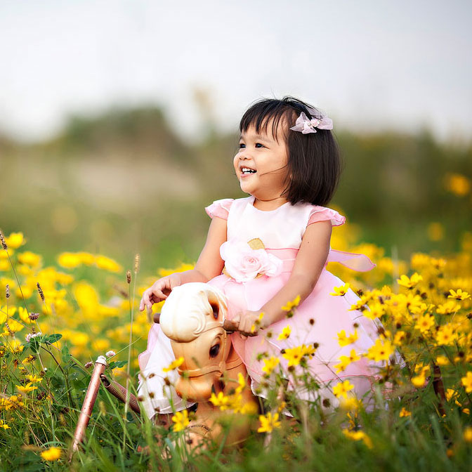 Home 7 Photo of a toddler laughing amongst flowers by Marmalade Photography